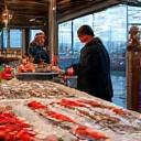 Fishermen at a lively market stall selling their catch, symbolizing economic development